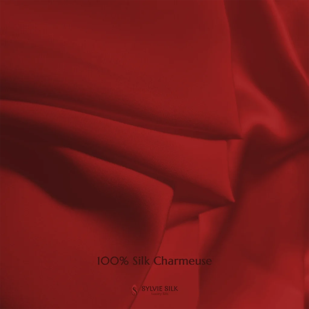 Scarlet Red 100% silk charmeuse fabric with luminous folds and a smooth lustrous face