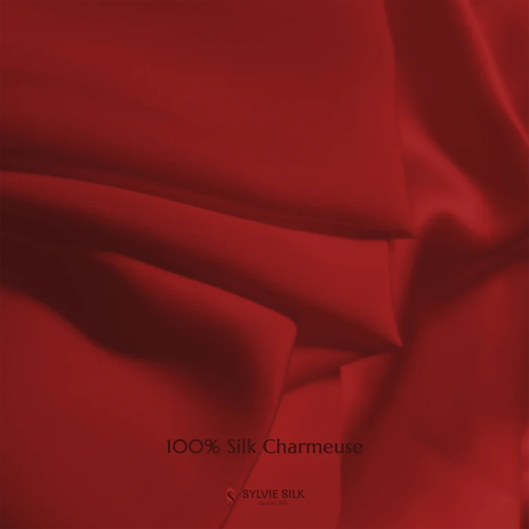 Scarlet Red 100% silk charmeuse fabric with luminous folds and a smooth lustrous face