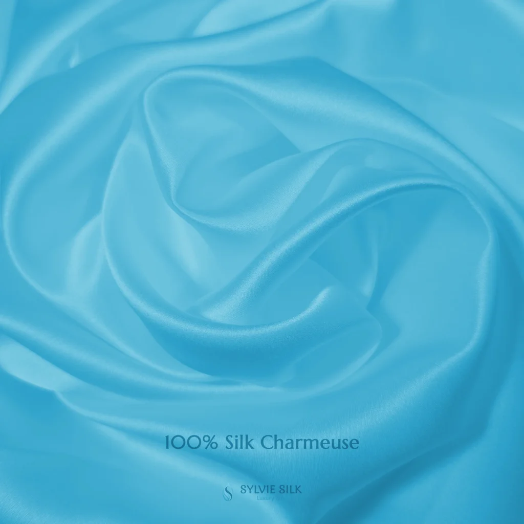 Glacier Blue 100% silk charmeuse fabric with luminous folds and a smooth lustrous face
