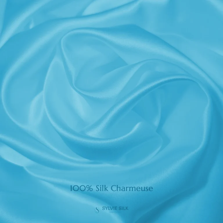 Glacier Blue 100% silk charmeuse fabric with luminous folds and a smooth lustrous face