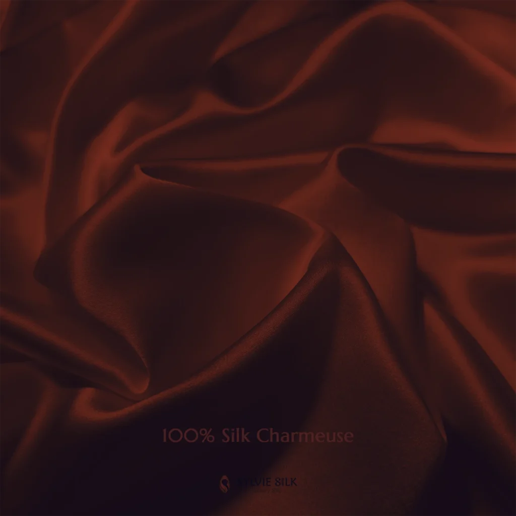 Burnt Sienna 100% silk charmeuse fabric with luminous folds and a smooth lustrous face