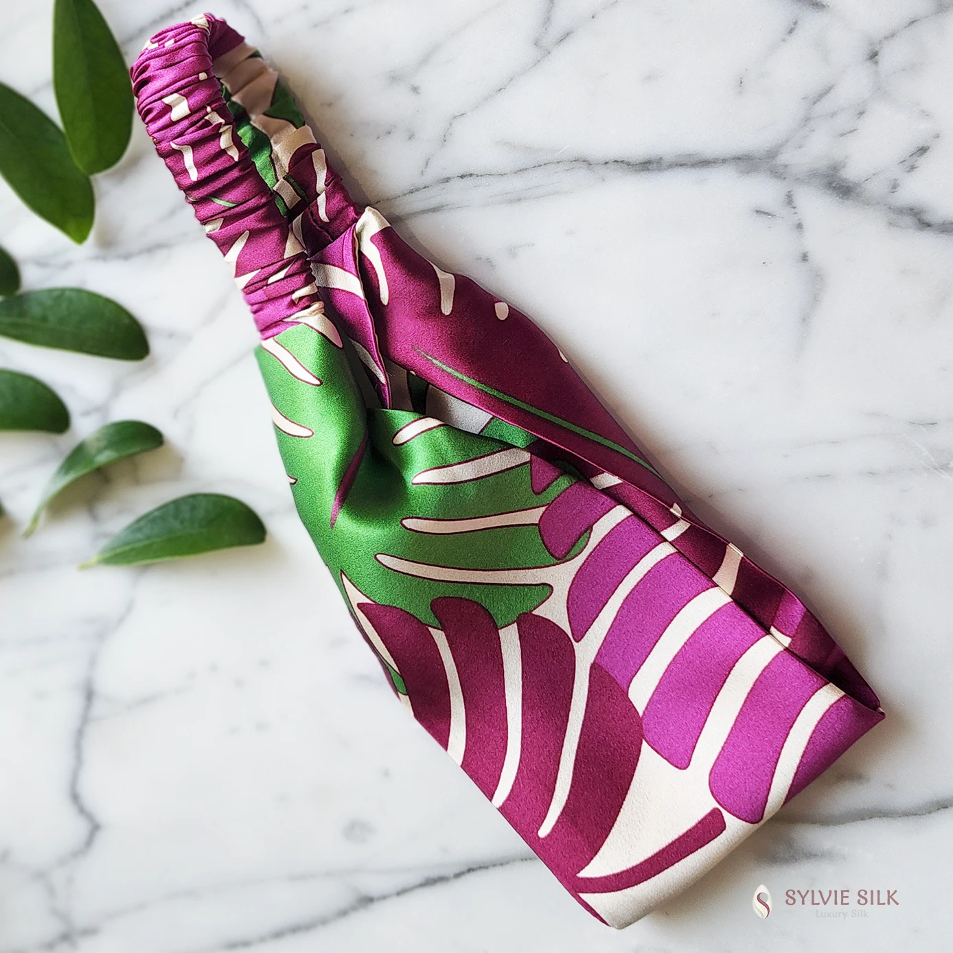 Monstera silk charmeuse flat headband showing the wide front and gathered silk-covered elastic back