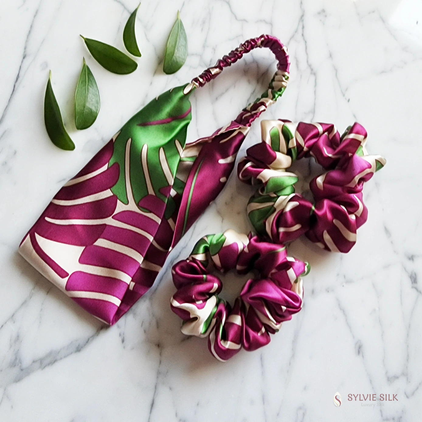 Monstera silk gift set arranged with one silk charmeuse headband and two matching scrunchies
